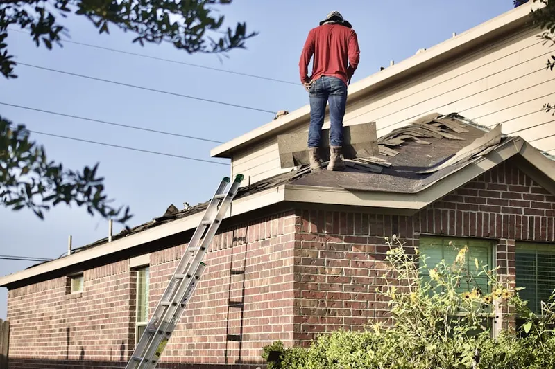Professional roofer working on a residential roof in Stallings